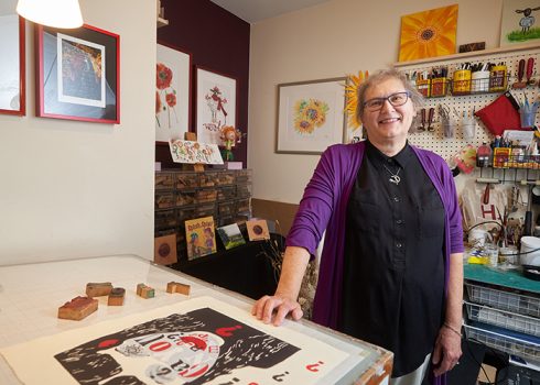 Arts Accessability Network Manitoba member Alice Crawford standing in her studio space.